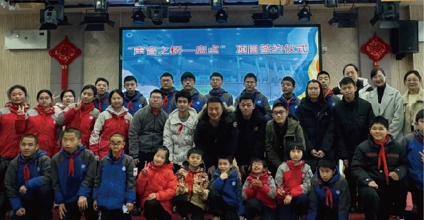 Students and partners at a project signing event.