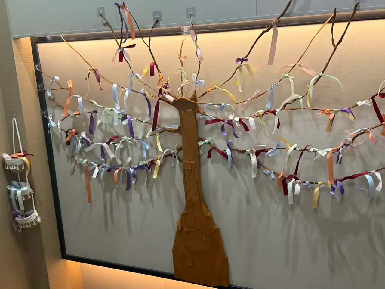 A tree-shaped ribbon installation at a Sisterhood Voice activity.